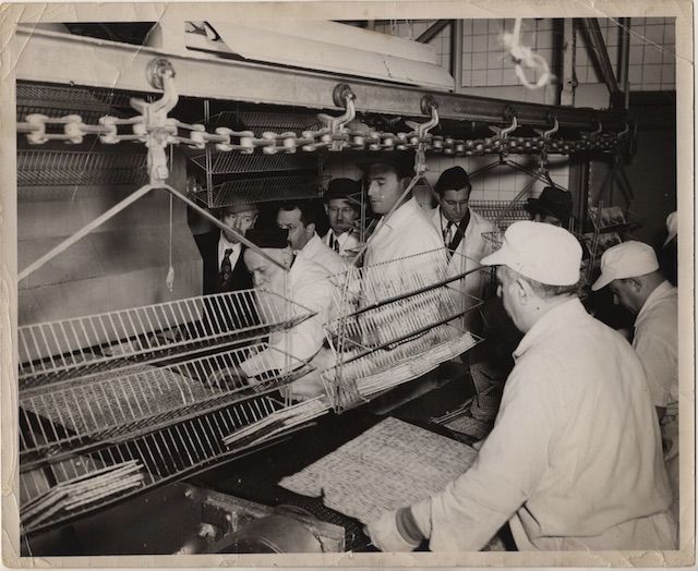 Matzo emerges from the first floor oven on Rivington Street, late 1940s. These factory photos were taken during Shmurah matzo production. One day each year, the factory would produce a special matzo intended for Orthodox consumers known as Shmurah (âguardedâ in Hebrew) matzo that met the most stringent specifications. Rabbis from around the world would attend and bring matzo home for their families and congregations. The tradition continued until the factoryâs closing in 2015